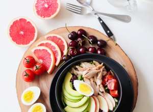 Table Setting With a Plate and Bowl of Fresh Fruits, Veggies and Eggs